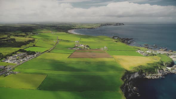 Hyperlapse Farmlands Fields Aerial View in Antrim County, Ireland. Fast-track Shot Above Countryside