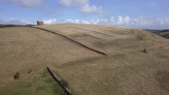 Forward tracking aerial towards the bottom of the hill that St Catherine's Chapel in Dorset sits. Ne