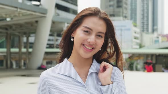 Asian young smart businesswoman working in company office, stand outdoor in city with smiling face