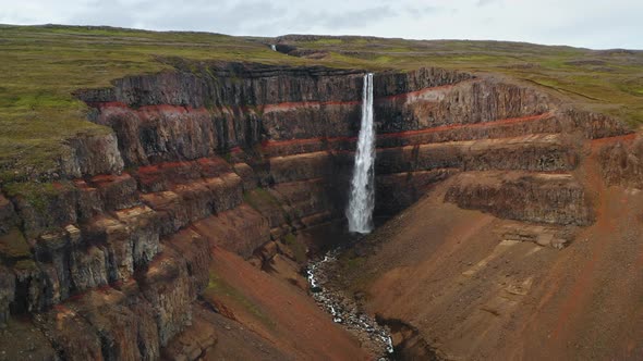 Aerial Footage of Hengifoss Waterfall Red Canyon and Mountain River in Iceland