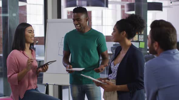 Mixed race business colleagues sitting having a discussion in meeting room