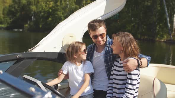 Father with Adorable Daughter and Wife Resting on Big Boat alt