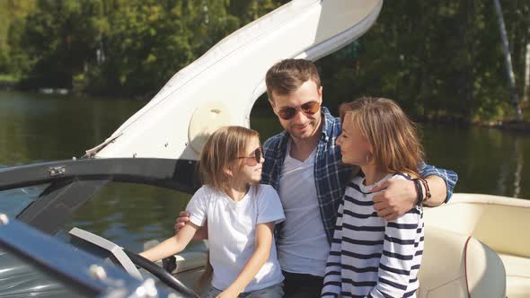 Father with Adorable Daughter and Wife Resting on Big Boat