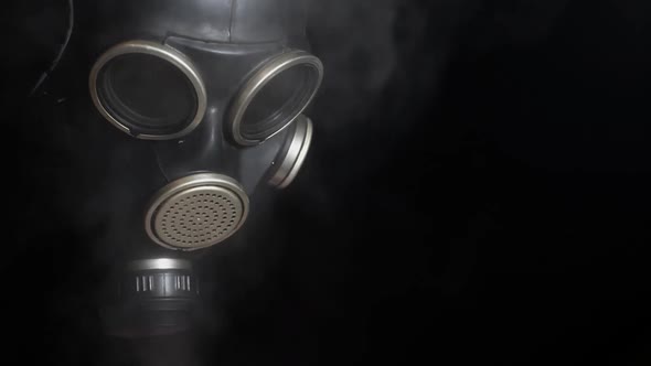 footage of gas mask smoke dark background