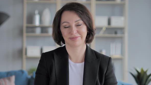 Portrait of Old Businesswoman Shaking Head To Accept Yes