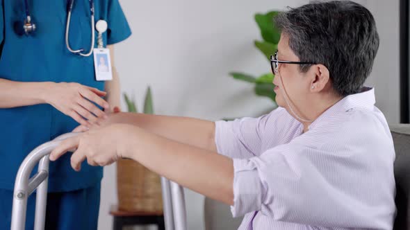 Nurses in nursing homes being care for the elderly woman help to walk by walker