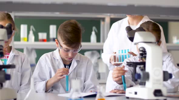 Teacher and Students Studying Chemistry at School 17