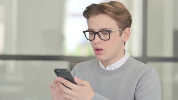 Young Man Having Loss While Using Smartphone