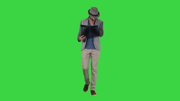 Casual Man Looking at X-ray of Lungs and Walking on a Green Screen, Chroma Key.