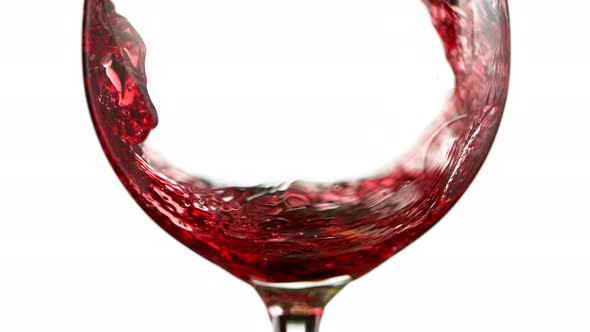 Super Slow Motion Detail Shot of Pouring Red Wine Isolated on White Background at 1000Fps