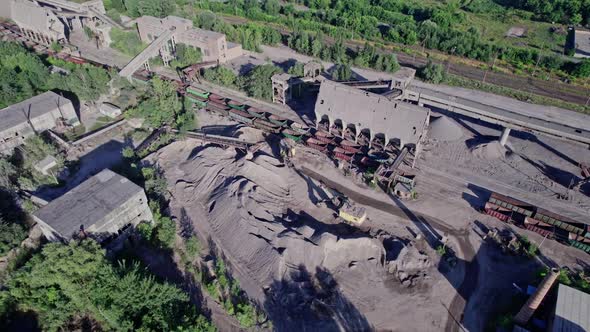 Excavator Loading Crushed Stone Into a Dump Truck in a Crushed Stone Quarry