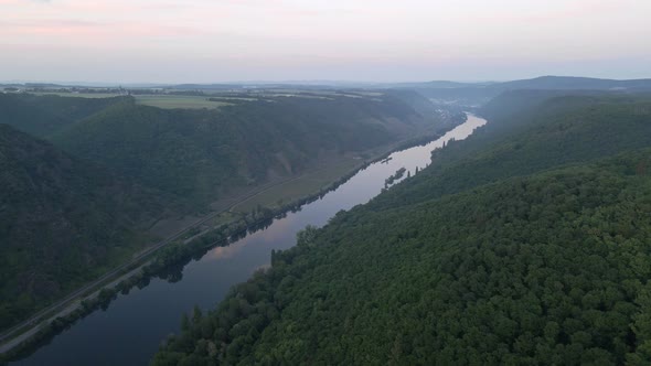 aerial footage of the river Moselle and its beautiful green forested hills near cochem at the Cochem