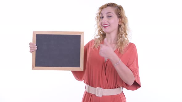 Happy Beautiful Blonde Businesswoman Holding Blackboard and Giving Thumbs Up