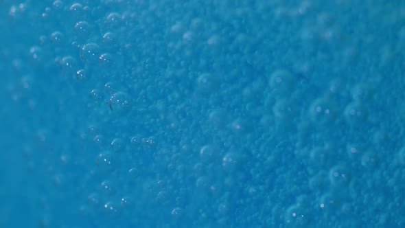 Close up footage of blue fizzy bubbles