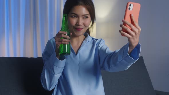 Asian lady drinking beer having fun happy moment night party event online celebration.