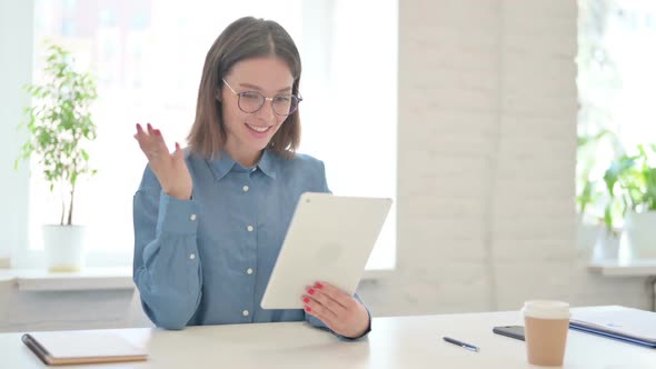 Young Woman making Video Call on Tablet in Office