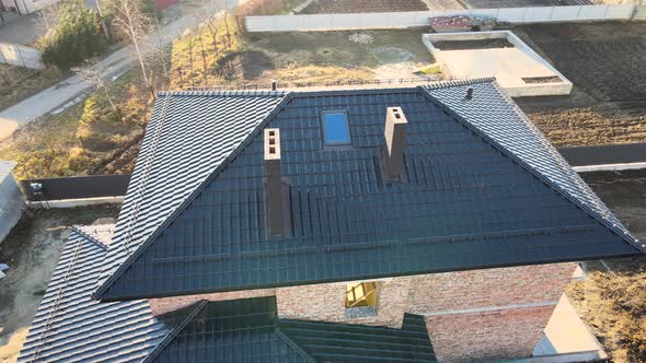 Aerial View of House Roof Top Covered with Ceramic Shingles