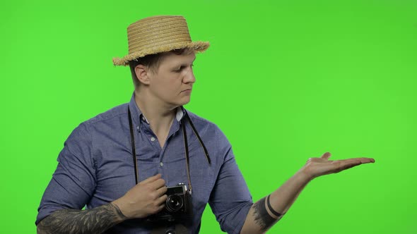 Portrait of Young Man Tourist Photographer Pointing at Something. Chroma Key