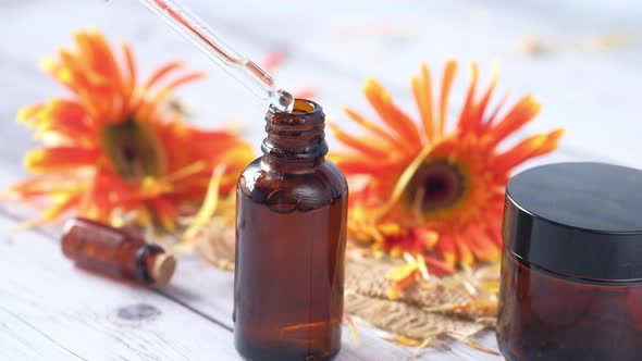 Drop Falls From a Pipette Into a Cosmetic Bottle