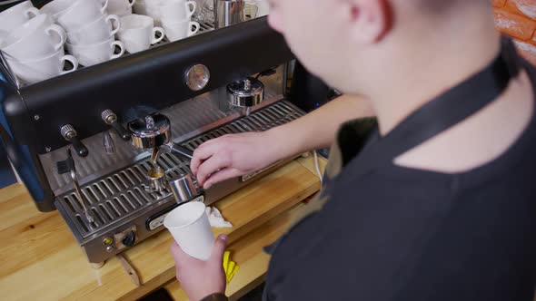 Process of Making Espresso in a Coffee Machine. Barista Making Latte in Specialty Coffee Shop.