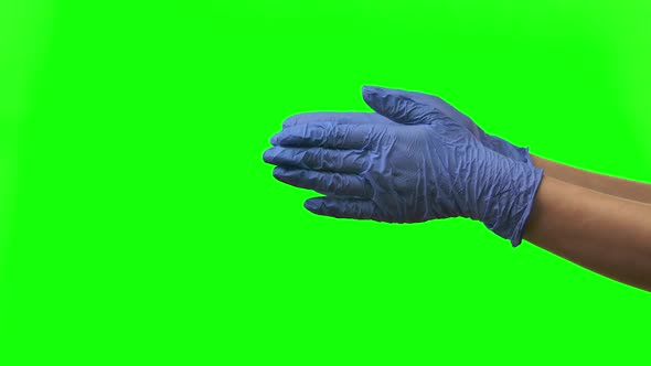 Doctors Female Hands in Blue Gloves Are Clapping. Green Screen. Close Up