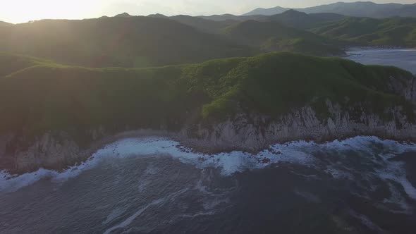 Aerial View of the Beautiful Sea Coast with Clear Blue Water at Sunset