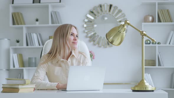Young woman with laptop at home office