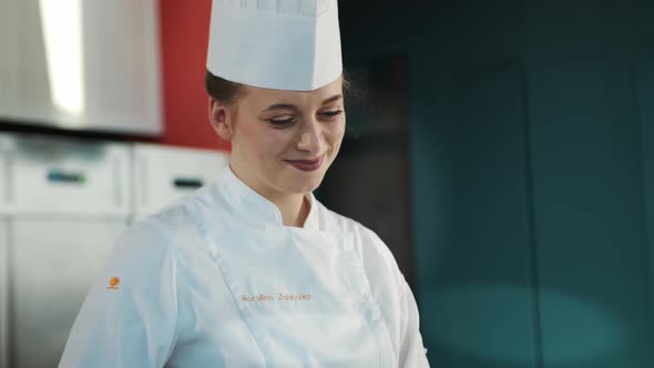 Close-up, portrait of a female: Chef prepares a delicious dish in a restaurant in a kitchen