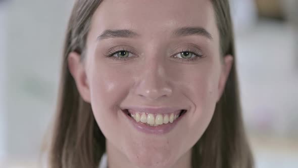 Close Up of Young Woman Smiling at Camera