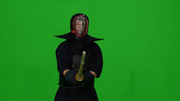 Masculine Kendo Warrior Practicing Martial Art with the Bamboo Bokken on Green Screen. CLose Up