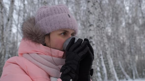 Young Woman Drinking Hot Tea in Cold Winter Day