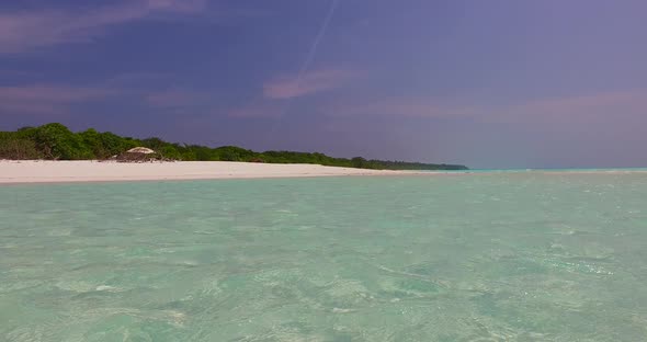 Wide fly over abstract view of a sunshine white sandy paradise beach and blue ocean background in 4K