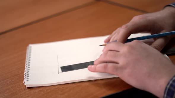 Man Draws on the Paper