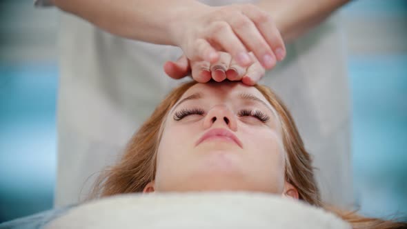 Massage - Masseuse Is Kneading Her Clients Face with Palms