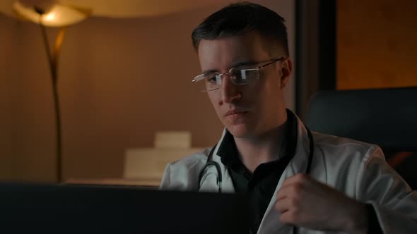 Caucasian Male Doctor Portrait with Stethoscope Behind Laptop