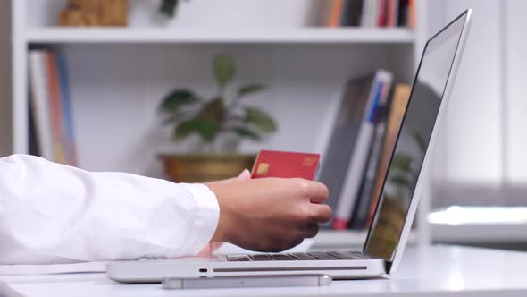 Woman's Hands Holding a Lot of Different Credit Cards and Via Smart Phone for Online Shopping. Close