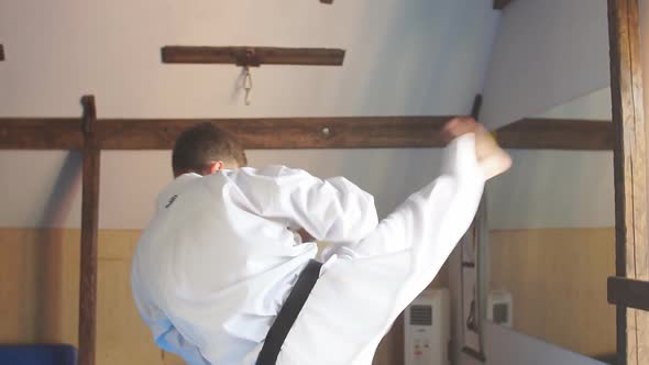 Man Training Karate in Gym