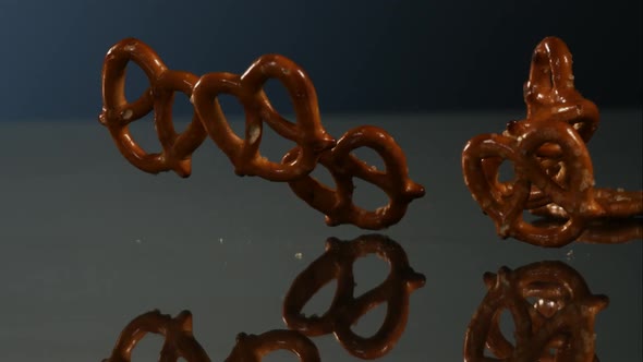 Pretzels falling and bouncing in ultra slow mo 1500fps - reflective surface - PRETZELS PHANTOM