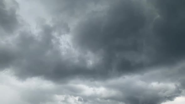 Dramatic big storming dark rain clouds on sky timelapse