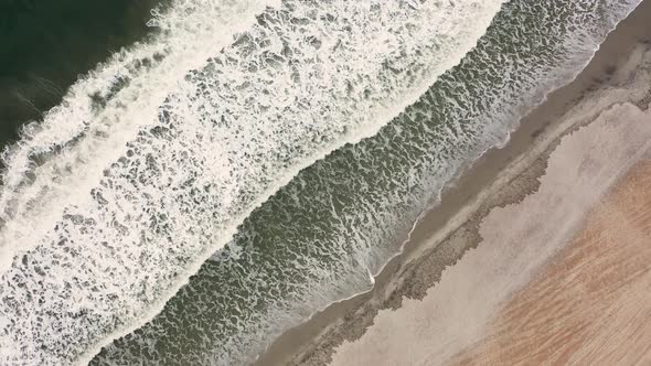 Drone Flying Over Ocean Waves Crashing on the Beach