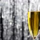Close up of two champagne glasses over holiday tinsel bokeh blinking background. - VideoHive Item for Sale