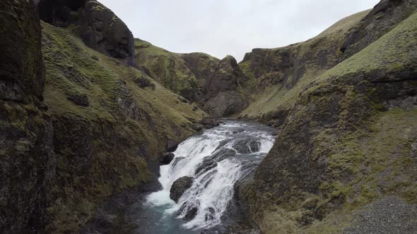 Flying through the ravine over the picturesque white water of Stjórnarfoss falls