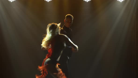 Elements of Fiery Latin American Dance Performed By Pair of Ballroom Dancers