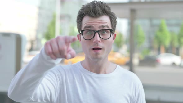 Young Man Pointing at the Camera Outdoor