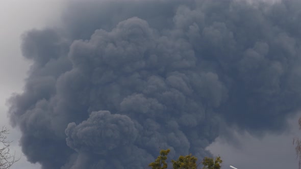 Thick black smoke covers the sky during the war between Ukraine and Russia