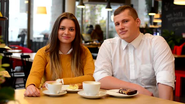 Happy Couple Smiles in Cafe (To Camera) - Coffee and Cake