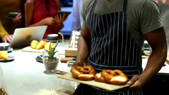 Waiter showing tray of pretzel 4K 4k