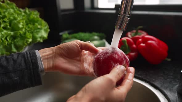 Woman Washing Fruits and Vegetables in Kitchen