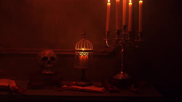 Mystical Halloween still-life background. Skull, candlestick with candles, old fireplace.