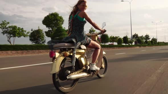 Woman Riding Motorbike in Slow Motion Along Highway Road in Slow Motion